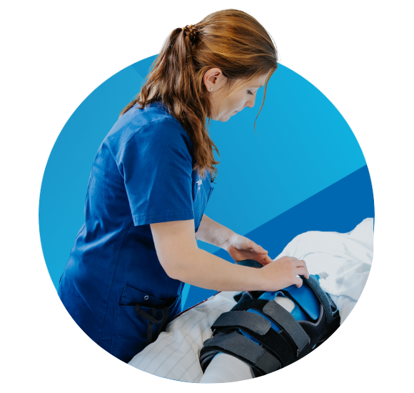 A nurse providing post-operative care to a patient in the recovery ward.