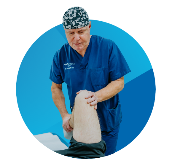 A specialist examining a patient's knee during a medical consultation.